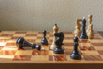 A chessboard with the defeated king on a textural background.