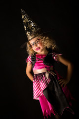 Attractive girl in witch halloween costume