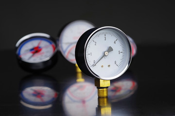 Manometer in focus. A pressure gauge on the background of other instruments.