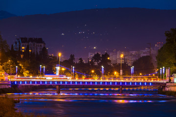 Fototapeta na wymiar Night view of illuminated Kubanskiy bridge and Sochi river on the background of mountain, Sochi, Russia 