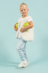 Pretty, cute girl in light clothes hold apples