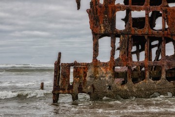Naklejka premium Rusty Abandoned Ship on Beach