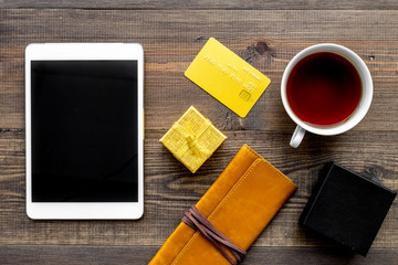 Order new year 2018 present with credit card and device on wooden background top view