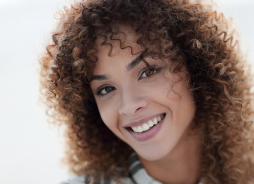 Close-up face of beautiful young woman with curly hair