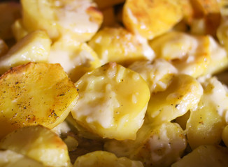 Baked spicy potatoes on tray.