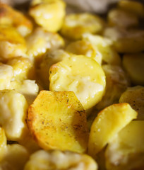 Baked spicy potatoes on tray.