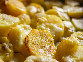 Baked spicy potatoes on tray.