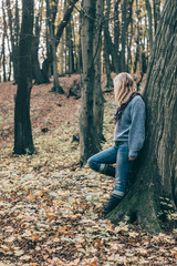Young woman walking in beautiful autumn forest