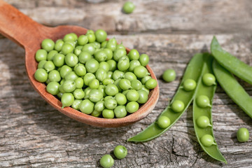 Fresh Green Peas on a green background. Macro