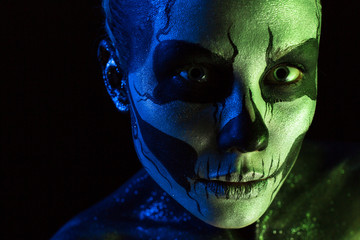 Attractive spooky girl with skeleton makeup