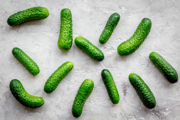 Fresh cucumbers on grey background top view