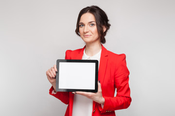 Picture of beautiful woman in red blazer standing with tablet in hands