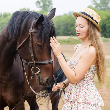 Girl in a straw hat with a horse / Photographed in Russia, at the racetrack in Orenburg