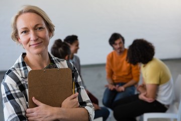 Portrait of teacher with students in background