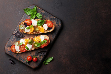 Bruschetta with tomatoes, mozzarella and basil - obrazy, fototapety, plakaty