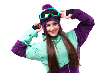 cheerful young pretty woman in purple ski coat and goggles