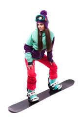 pretty young woman in purple ski suit rides black snowboard