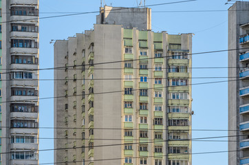 Urban background of the facades of multi-storey apartment buildings against the background of a clear sky