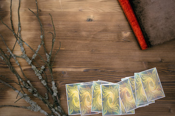 Tarot cards and book of magic on wooden table background with copy space. Future reading.