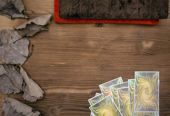 Tarot cards and book of magic on wooden table background with copy space. Future reading.