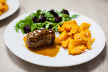 Carrot noodles, beef roulades and salad with beets and rocket salad