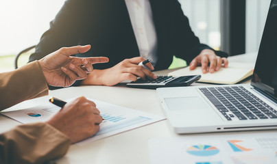 Business concept. Business people discussing the charts and graphs showing the results of their successful teamwork.