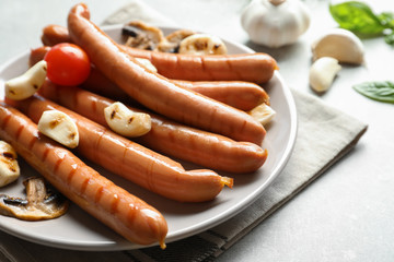 Grilled sausages served with garlic on plate