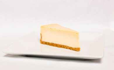 Cheesecake slice on white plate , isolated on white background