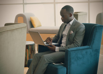 Business man holding his laptop and looking into chart