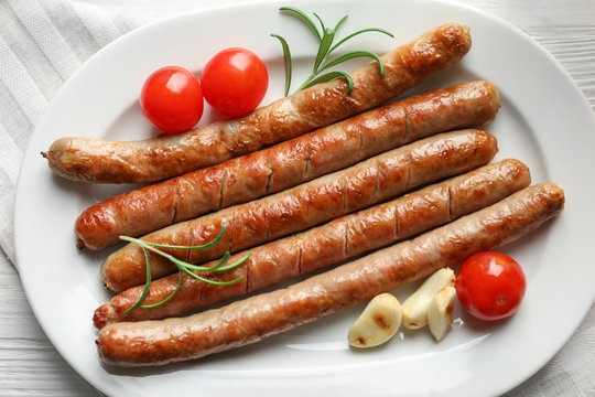 Plate with delicious grilled sausages, close up