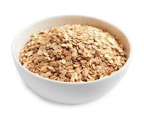 Bowl with raw oatmeal on white background