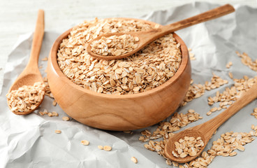 Bowl with raw oatmeal on table
