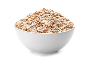 Bowl with raw oatmeal on white background