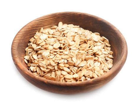 Plate with raw oatmeal on white background