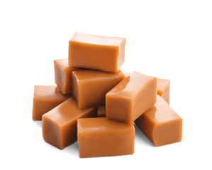 Sweet caramel candies on white background