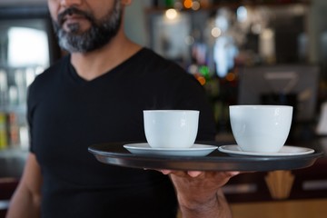 Fototapeta na wymiar Waiter holding coffee cup