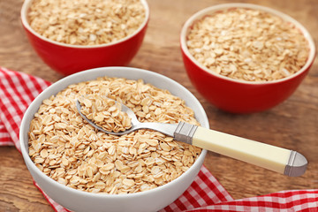 Bowl with raw oatmeal on table