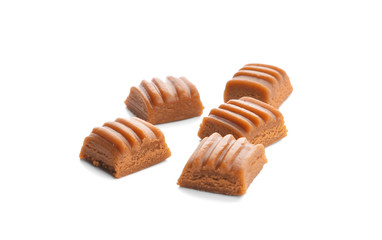 Sweet caramel candies on white background