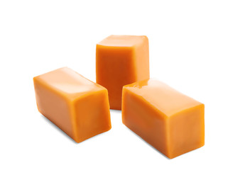 Sweet caramel candies on white background