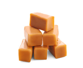 Sweet caramel candies on white background
