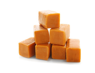 Sweet caramel candies on white background