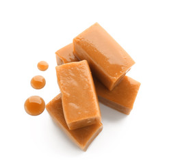 Sweet caramel candies on white background