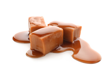 Sweet candies with caramel topping on white background