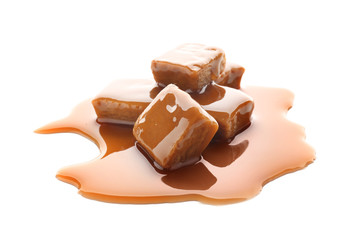 Sweet candies with caramel topping on white background