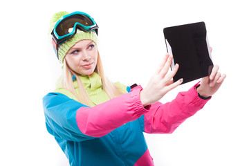 pretty blonde woman in ski costume with tablet