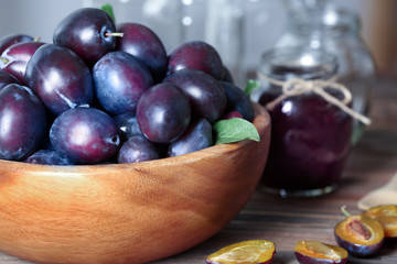 Bowl with plums on table, closeup