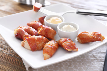 Bacon wrapped chicken on plate, closeup