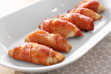 Bacon wrapped chicken on plate, closeup