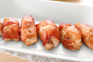 Bacon wrapped chicken on plate, closeup