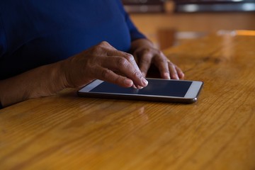 Waitress using digital tablet in cafe